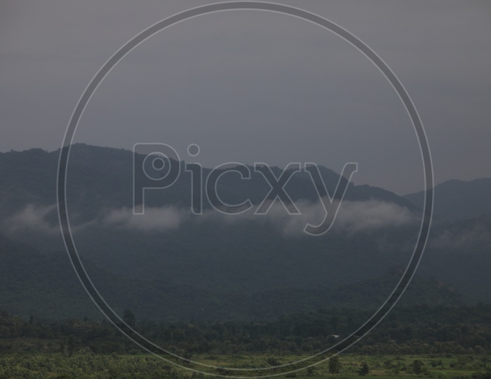 Landscape Of Green Plateaus And  Terrain Hills Filled With Fog