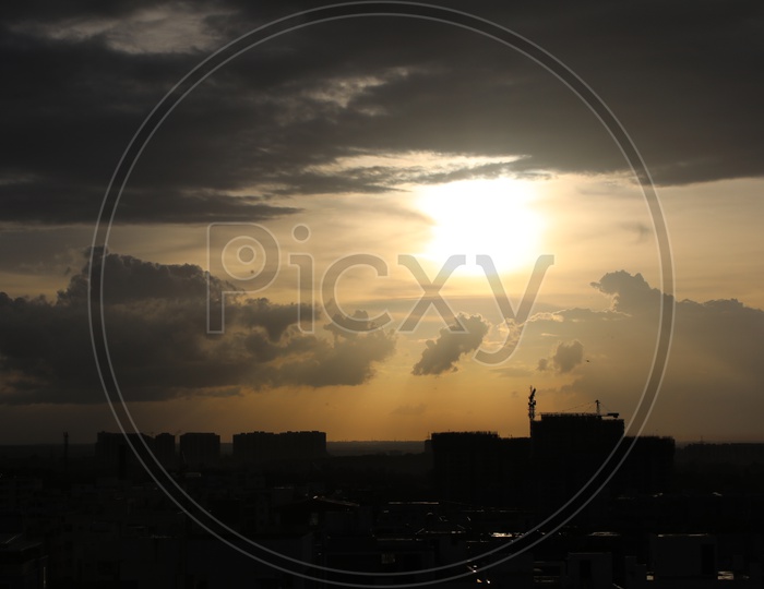 Silhouette Of  High Rise Buildings Over City Scpae With Sunset Background