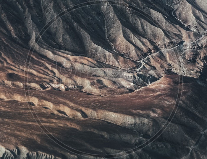 Aerial View Of Valleys And Sand Dunes From Flight Window