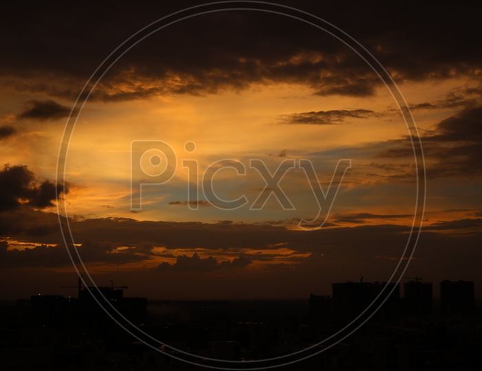 Hyderabad City Scape with Dark Clouds In Sky With Golden Hour Sunset Colour Pallet  Forming a Background