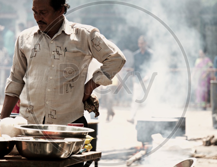 a man cooking food for people