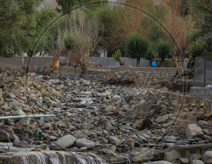 A Water Channel Flowing Over Stones In Ladakh