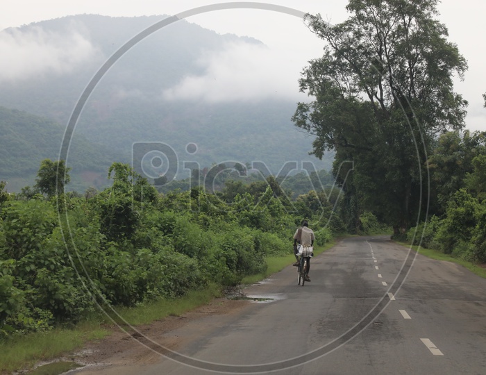 A Rural Indian Man Riding Bicycle on Rural Village Roads