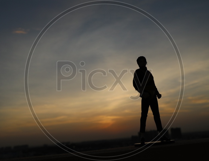 Silhouette Of Michel Jackson Toy Miniature Over Sunset Golden Hour Sky Background