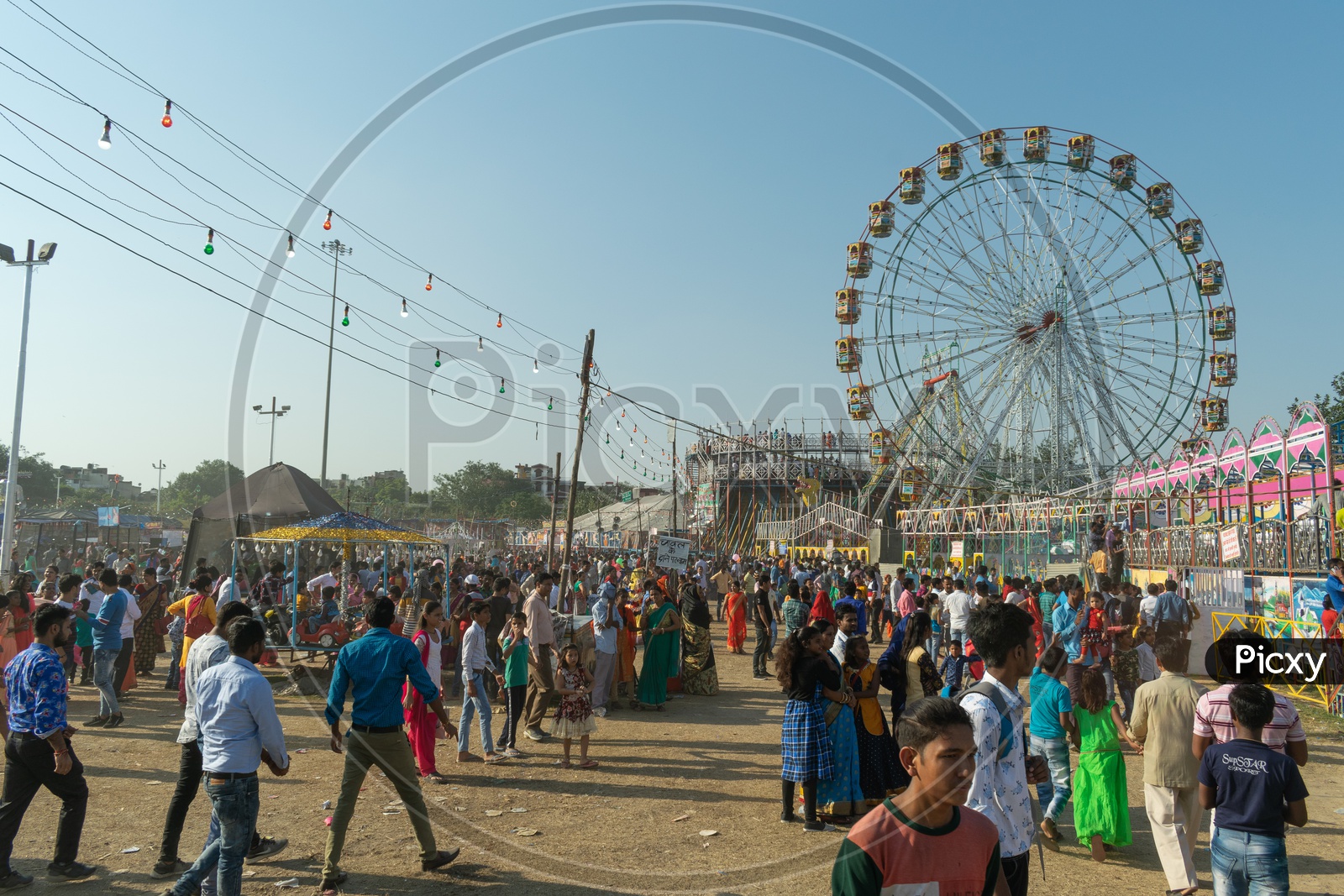 Ferris wheel during fair on Dusshera(Vijayadashami,Dashehra, Dasara) and people enjoying themselves at the fair