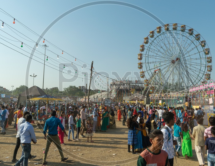 Ferris wheel during fair on Dusshera(Vijayadashami,Dashehra, Dasara) and people enjoying themselves at the fair