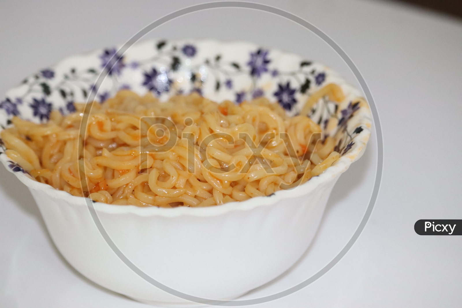 Cooked chinese instant noodles in bowl and chopsticks. - Image