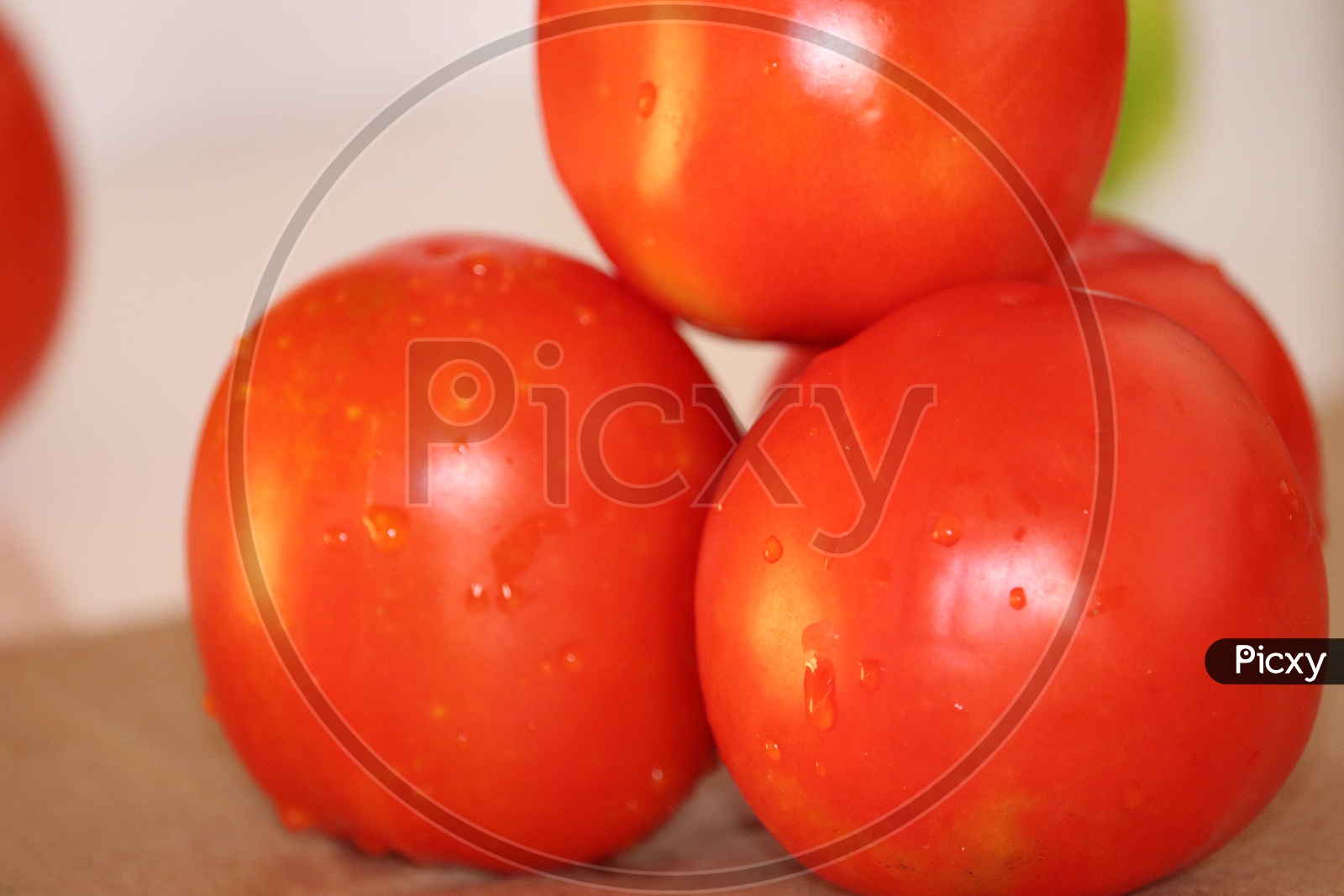 close up of fresh red delicious tomatoes on an old wooden tabletop background with place for text. Color toning. - Image