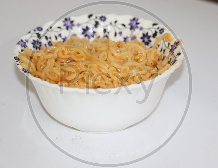 Cooked chinese instant noodles in bowl and chopsticks. - Image