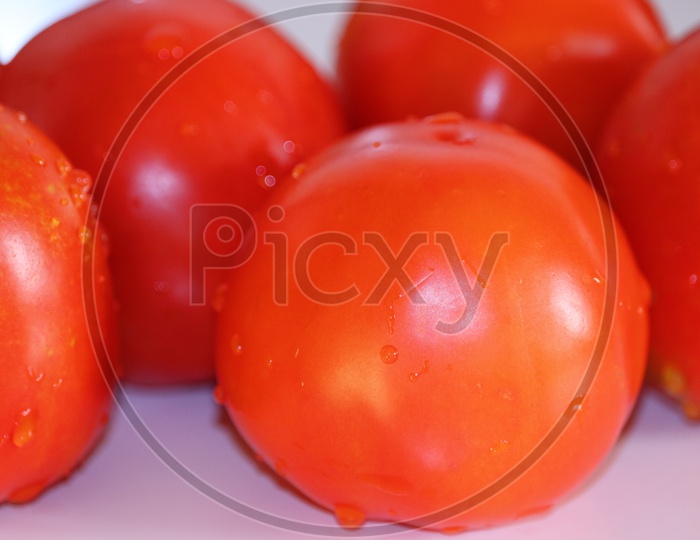 Image Of Close Up Of Fresh Red Delicious Tomatoes On An Old Wooden image-of-close-up-of-fresh-red-delicious-tomatoes-on-an-old-wooden
