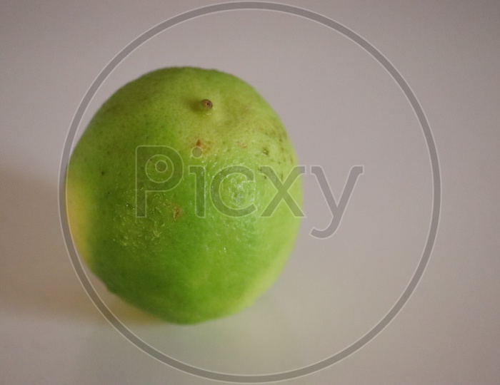 Beautiful light green lemons on a white background - Image