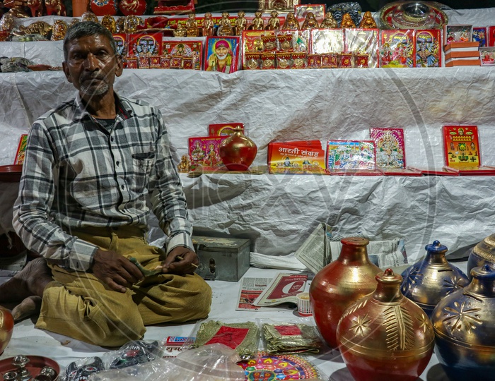 Street vendor selling photo frames of Hindu Gods and Goddesses and coin boxes