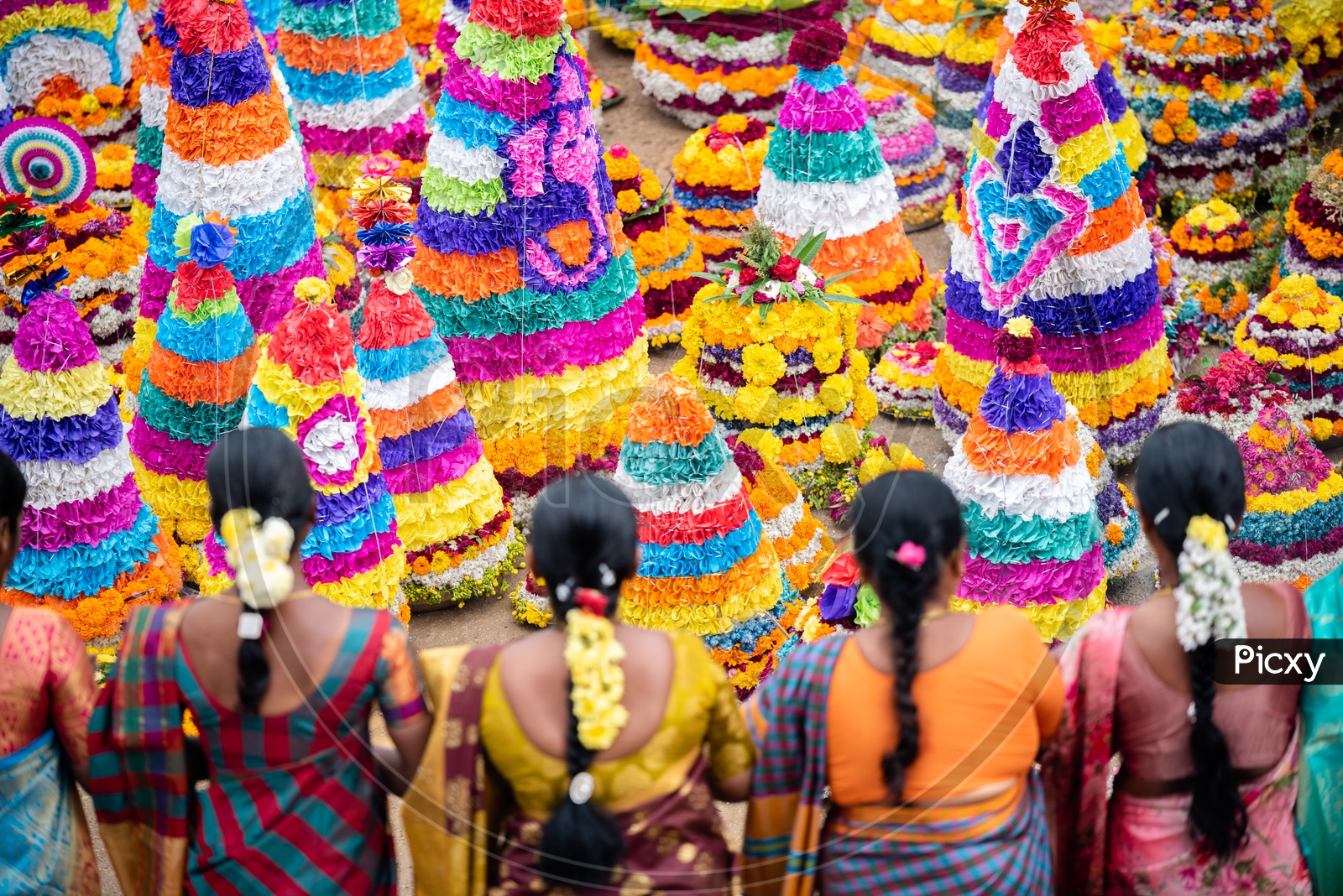 Women of Telangana celebrate Bathukamma by making Floral decoration s and dancing in front of them.
