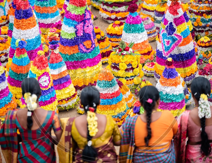 Women of Telangana celebrate Bathukamma by making Floral decoration s and dancing in front of them.