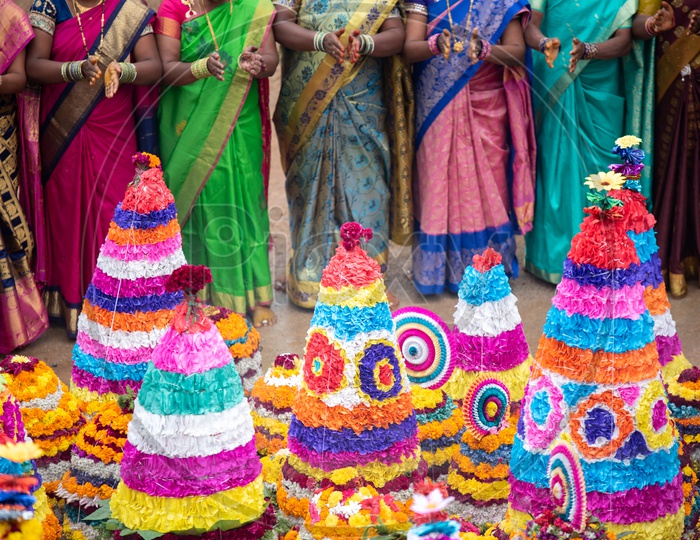 telangana women dance at Bathukamma, a floral decoration made from medicinal flowers and fragrances arranged like a temple gopuram.