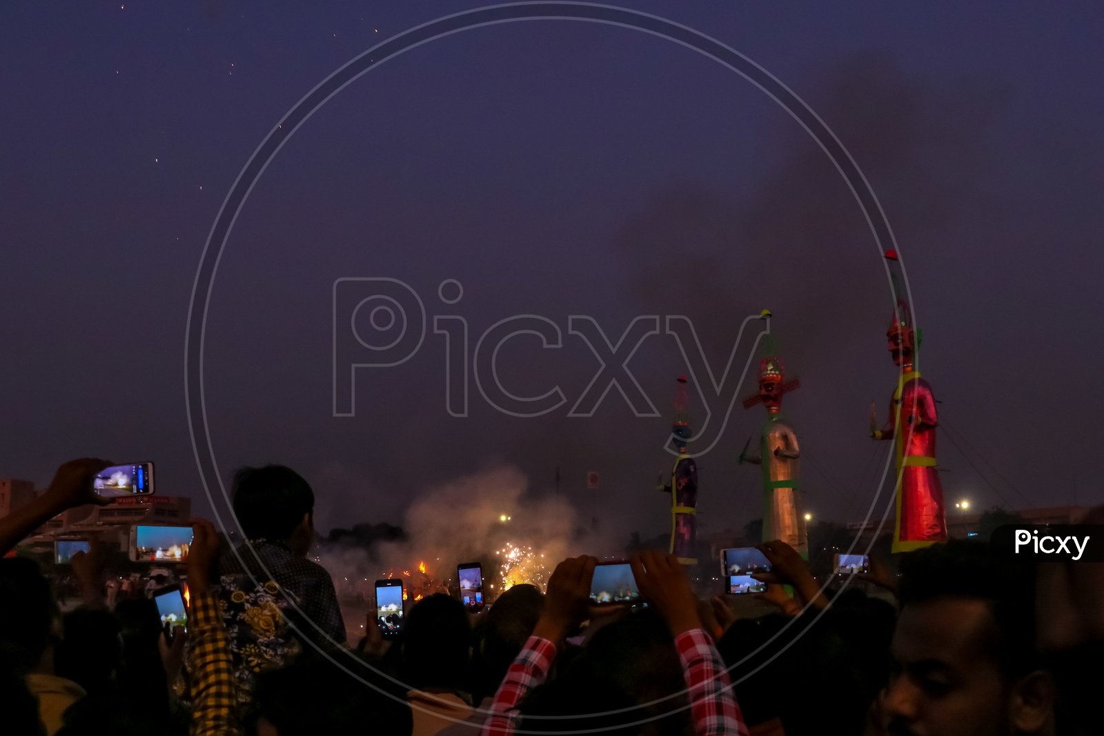 Crowd taking photos and videos of fire crackers near effigies of Ravan during Dussehra celebrations, 2019.