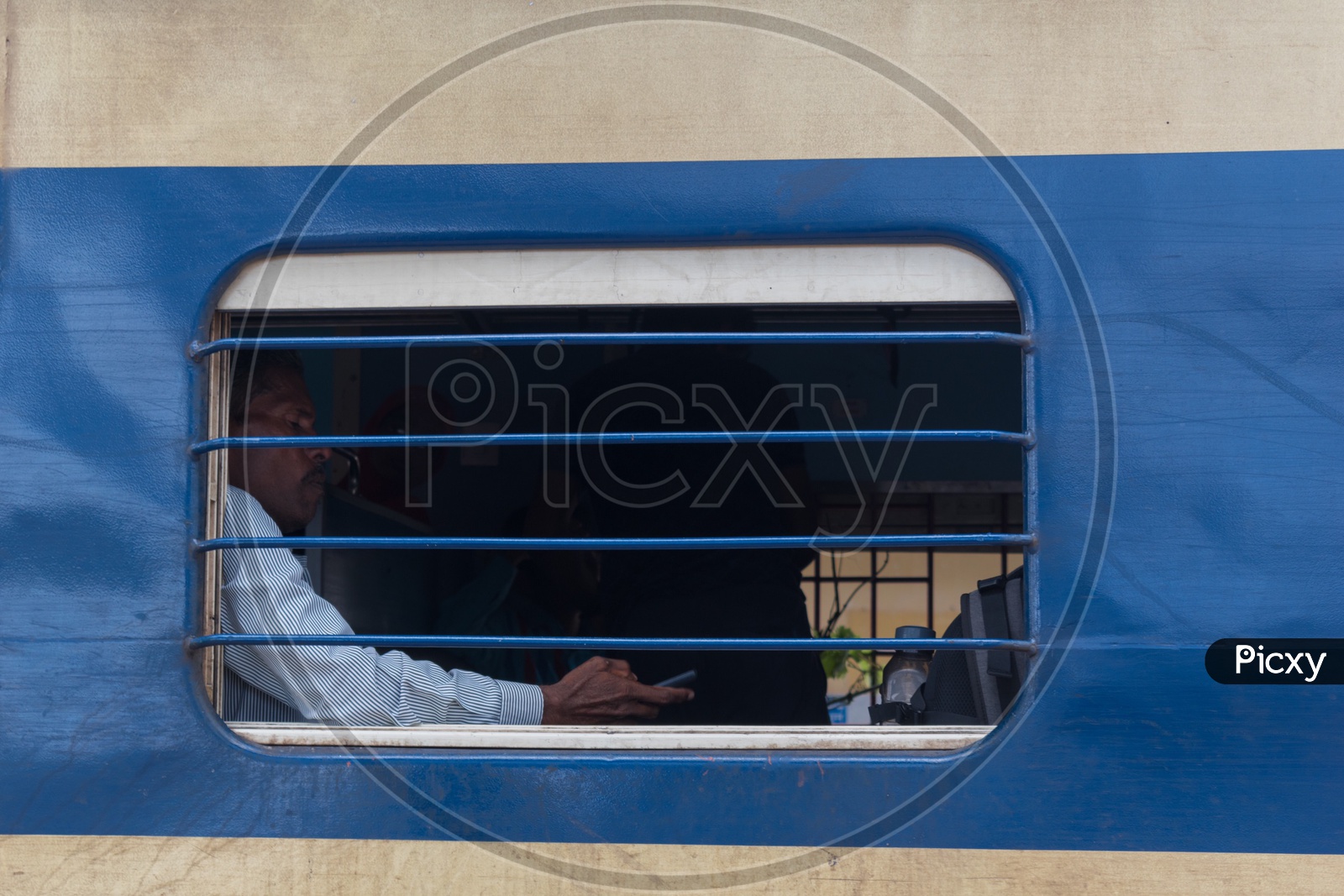 Man sitting near train window