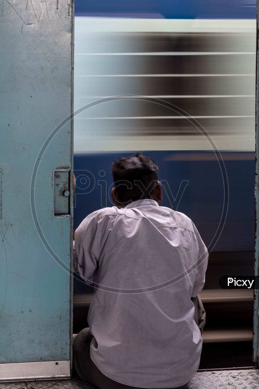 Man sitting at trains door