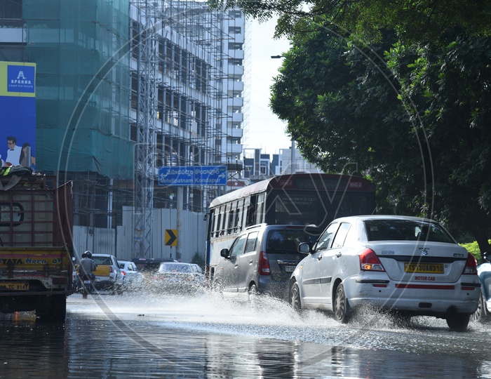 Commuting Vehicles Taking Narrow Paths Due to Stagnated Or Overflowing Drainage Or  Sewage Water At Kothaguda Signal in Hyderabad