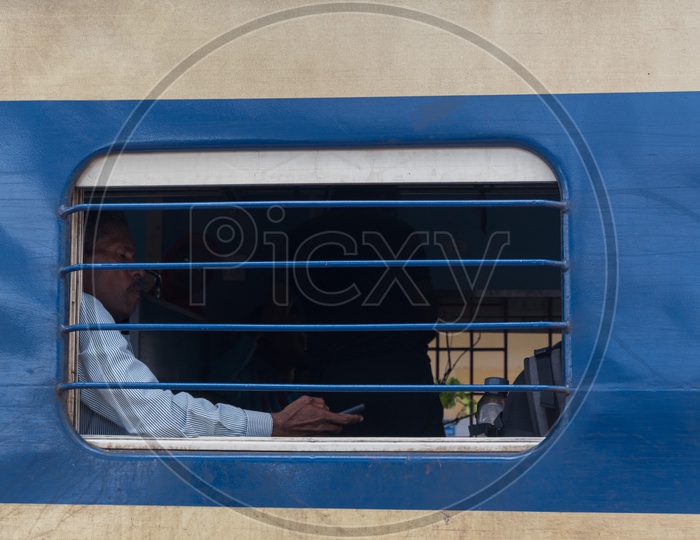Man sitting near train window