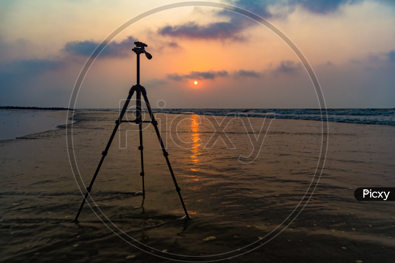 Tripod In Background Of Sunrise At Sea Beach For Beach Photography With Space For Text