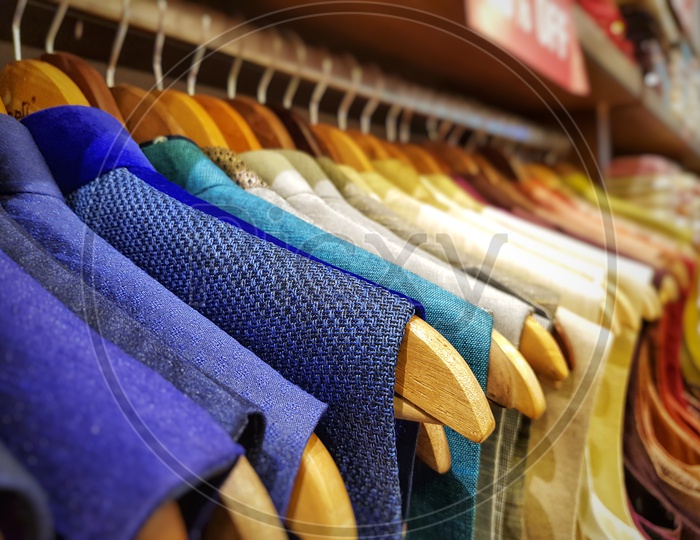Multi Color Dress Sherwani Kurta Hanging From Hangar In A Garment Shop For Sale