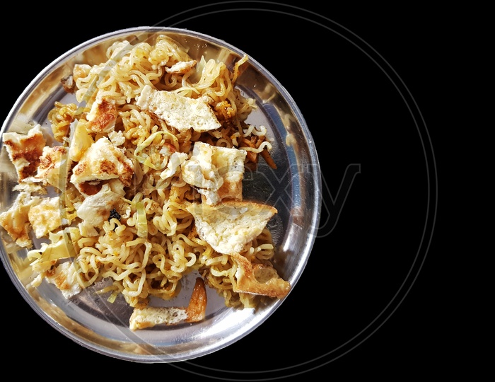 Fried Noodle On A Steel Plate With Fried Eggs In Black Background With Space For Text