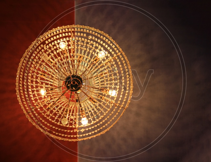 A Round Shaped Chandelier Hanging From Ceiling And View Directly From Below