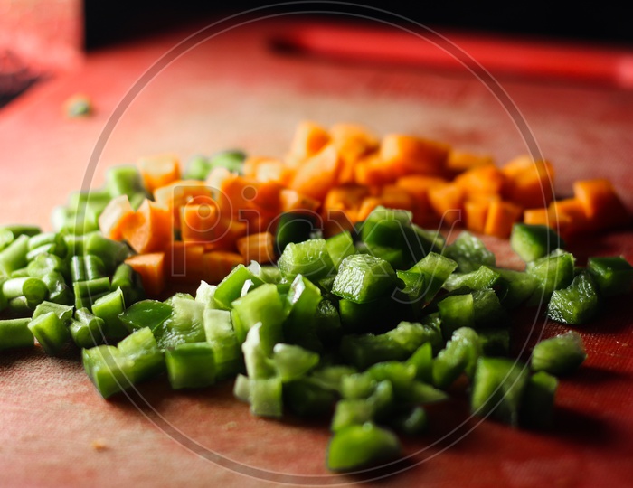 Capsicum And Carrot Cut Into Small Pieces,Finely Chopped Vegetables On A Chopping Board