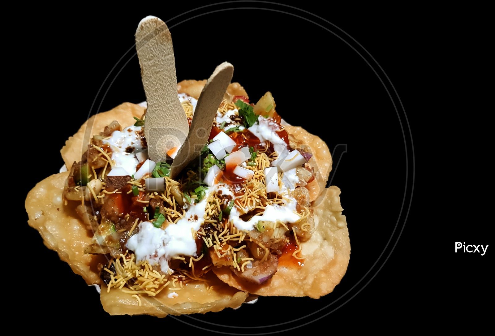 papdi chaat indian spicy snack isolated in black background
