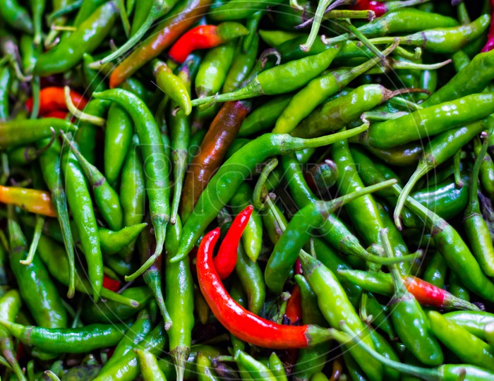 Heap Of Green And Red Chillis In Retail Vegetable Super Market For Sale