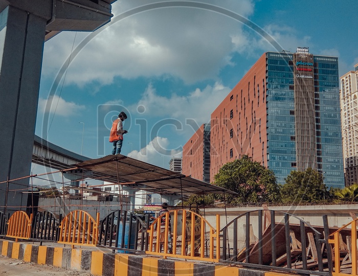 A Construction Worker With The Skyview Building In Background