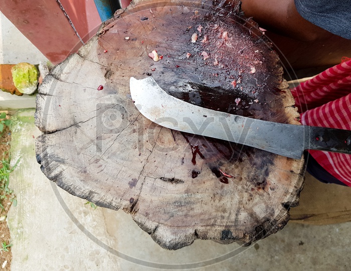 Curved Meat Chopper Butcher Knife On A Wooden Platform