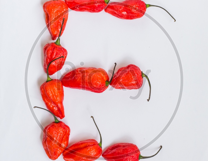 Letter E Alphabet Made With Ghost Pepper Bhoot Jolokia Over White Background