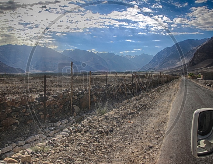 View Of A Road From A Car Window With Blue Clouds In Ladakh, India