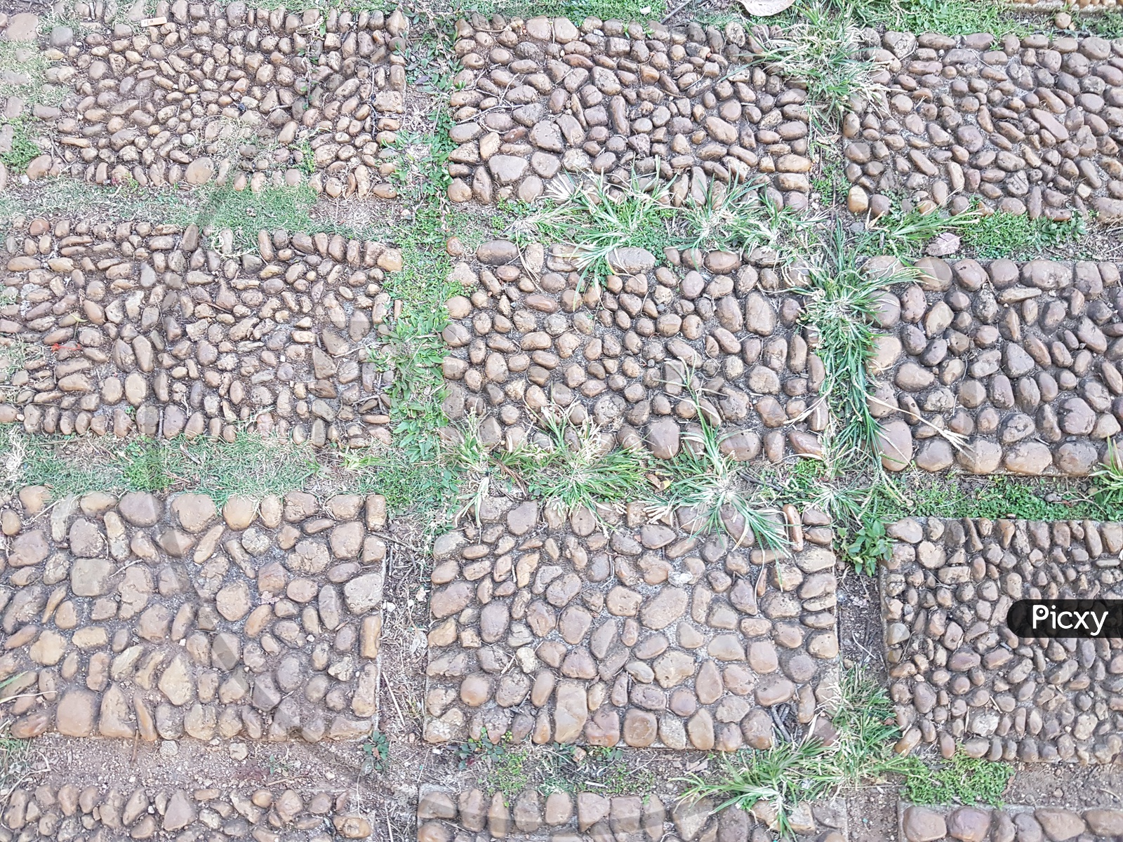 Texture Background of Stone Pebbles Brick On a Foot Path Forming a Background