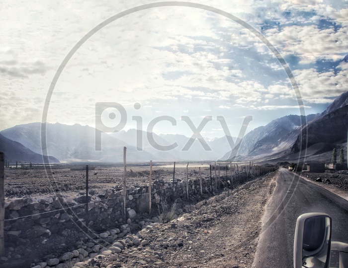 View Of Road From A Car Window With Blue Skies And Clouds. Road Trip Travel Landscape