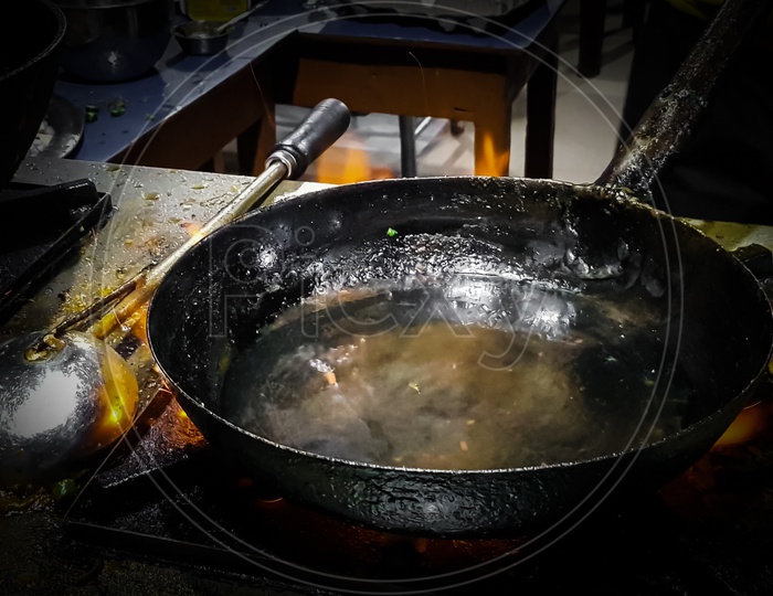 Cooking Tadka Fry In A Frying Pan At A Road Side Food Corner On A Stove Over Flames