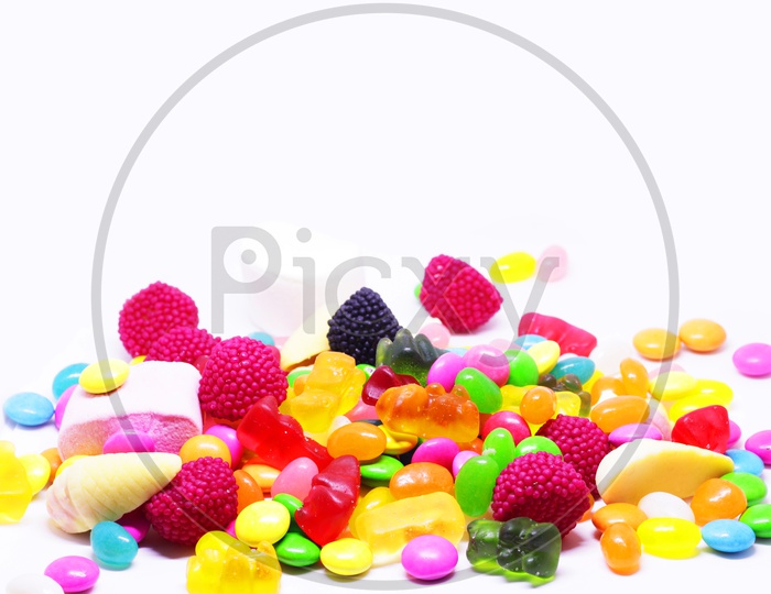 Multiple Colored Sugar Candy In White Background With Space For Text