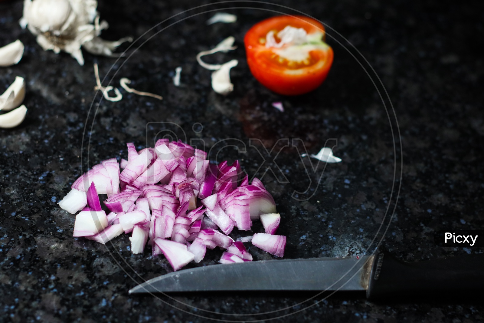 Finely Chopped Onion And Tomato And Knife On Granite Background