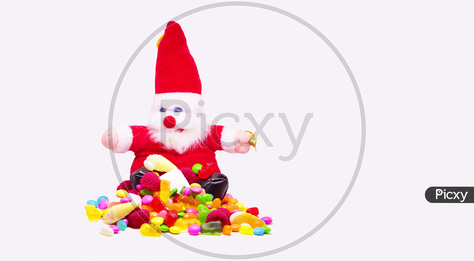 Santa Clause And Multi Colored candy In White Background With Space For Text, Christmas Celebrations