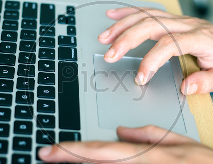 Fingers Operating Touchpad Of A Laptop