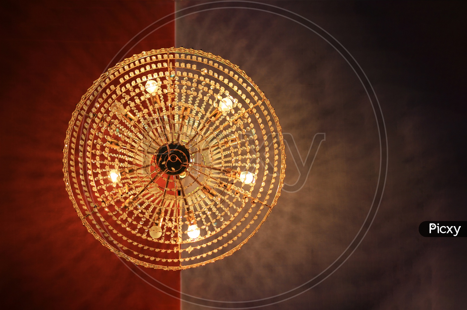A Round Shaped Chandelier Hanging From Ceiling And View Directly From Below