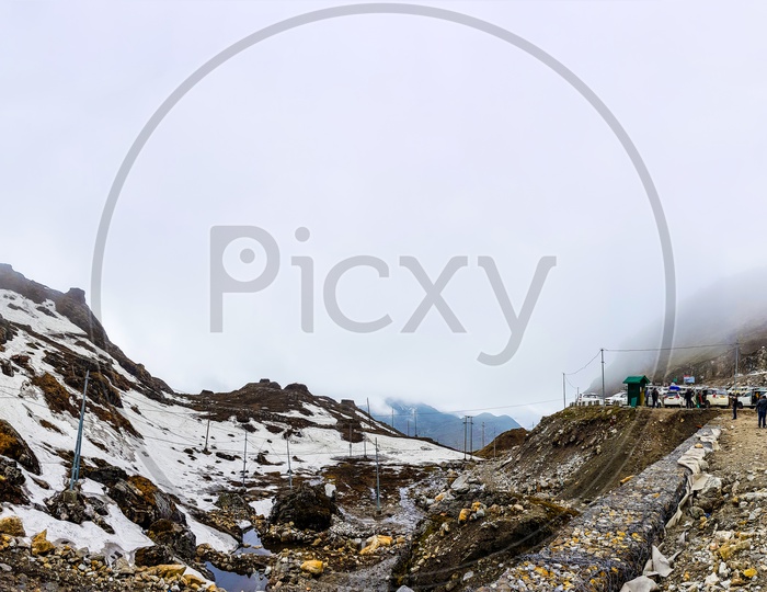 July,2018,Nathu-La, Sikkim, India. A Panoramic View Of Nathu-La Pass With Tourists And Parked Cars.At Sikkiim, India. Nathu-La Marks The Indo Chinese Border And Is A Very Popular Tourist Attraction