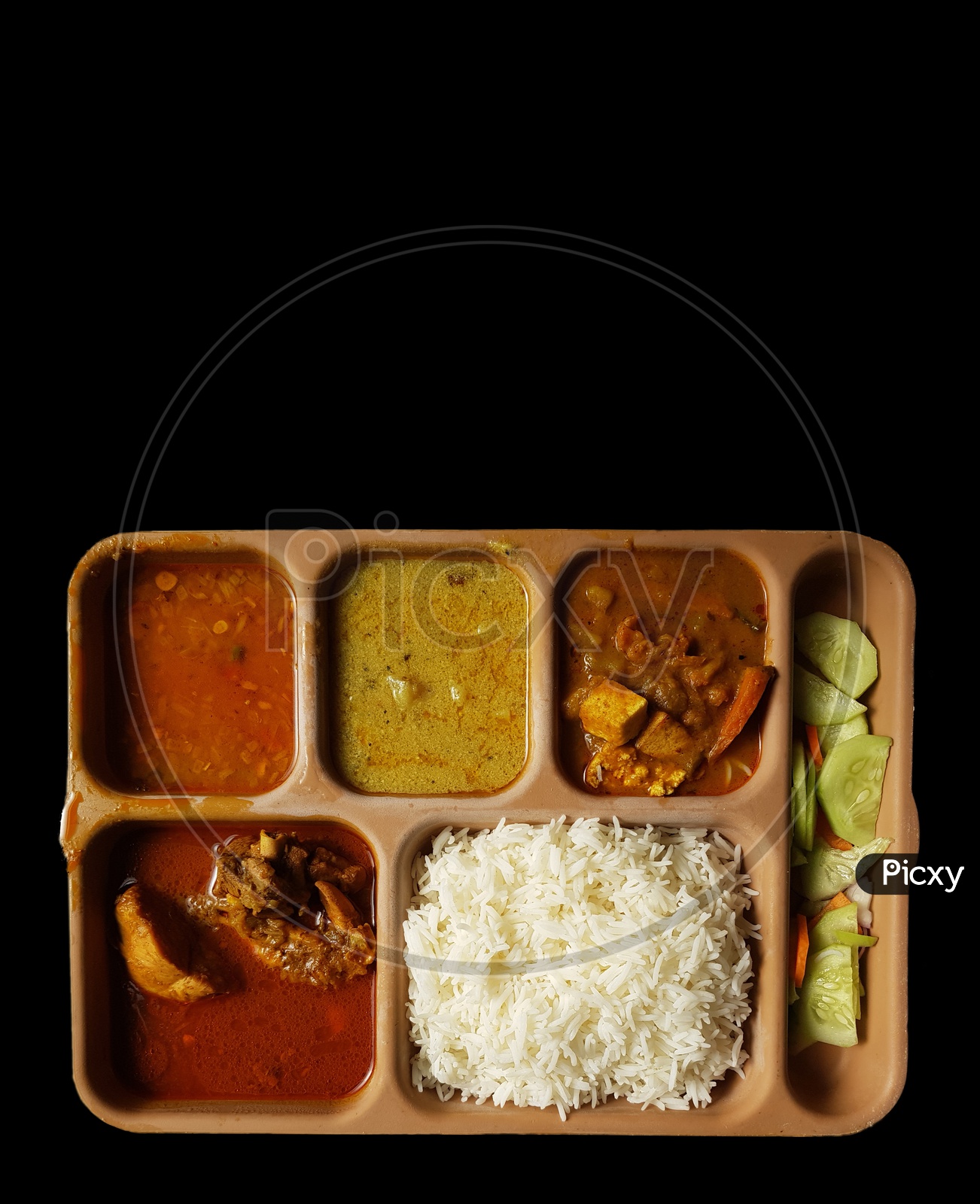 Indian Chicken Thali With Rice Dal Chicken Salad Vegetable Curry On A Plastic Segmented Plate In Black Background