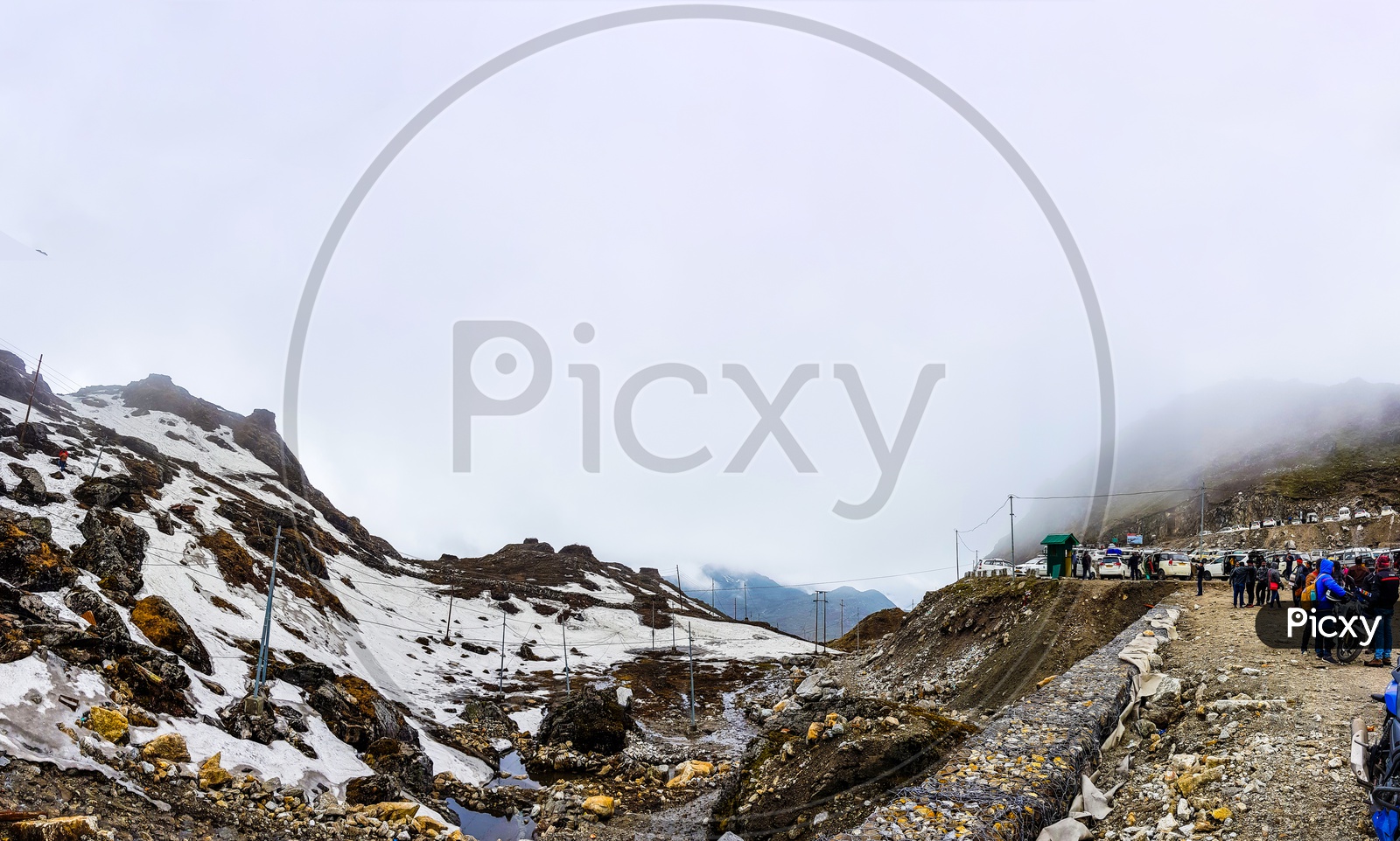 July,2018,Nathu-La, Sikkim, India. A Panoramic View Of Nathu-La Pass With Tourists And Parked Cars.At Sikkiim, India. Nathu-La Marks The Indo Chinese Border And Is A Very Popular Tourist Attraction