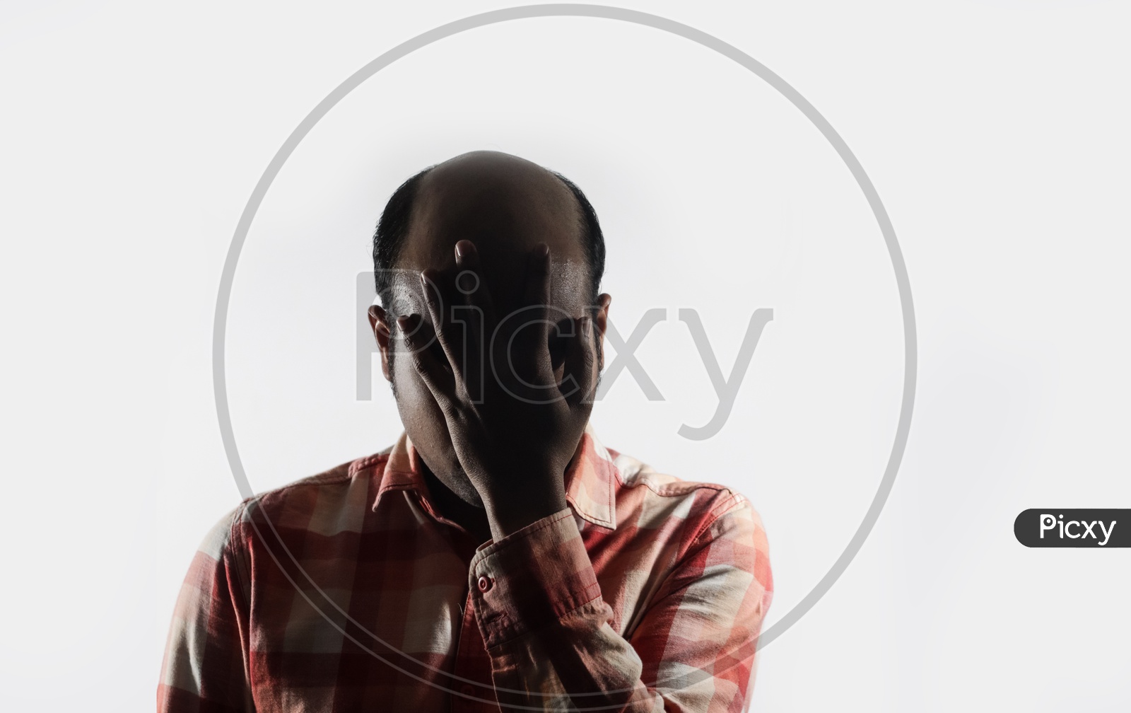 Bald Man Covering His Face In Shame In White Background With Space For Text