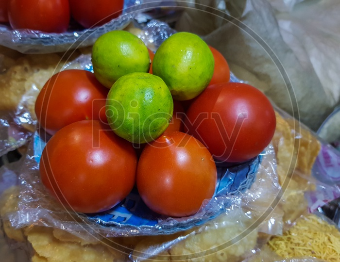 Lemon And Tomato On A Plate In A Chaat Shop