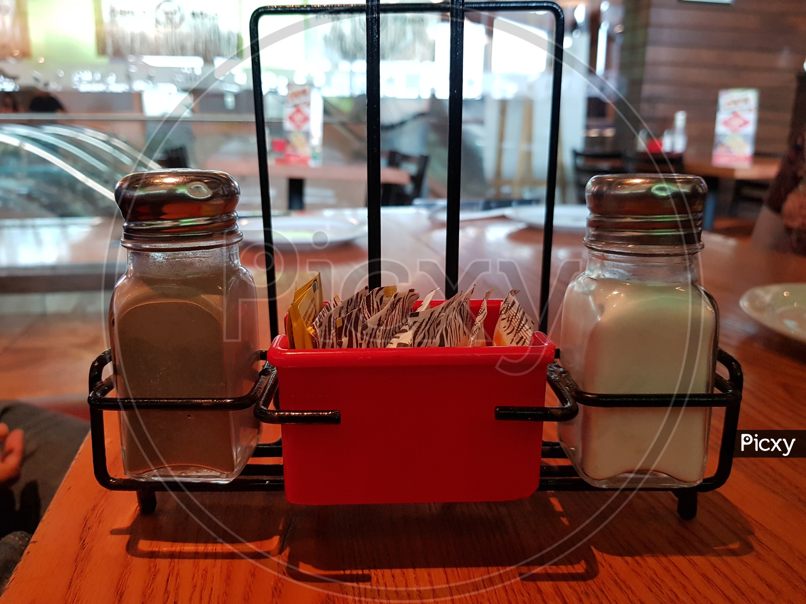 salt and pepper container on a table in a restaurant