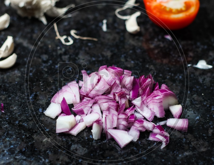 Finely Chopped Onion And Tomato On Granite Background